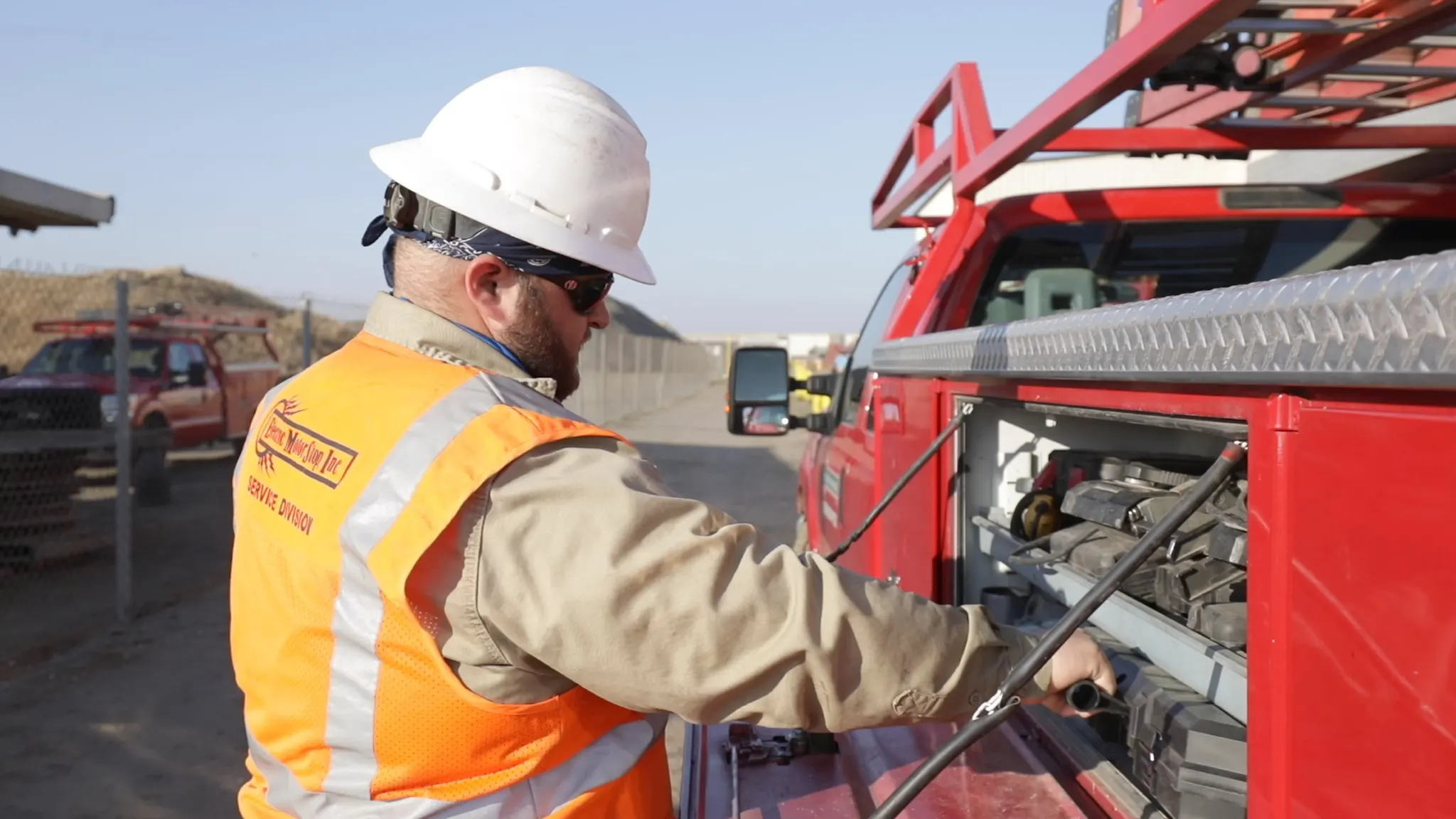 Electrician grabing a tool from repair truck.