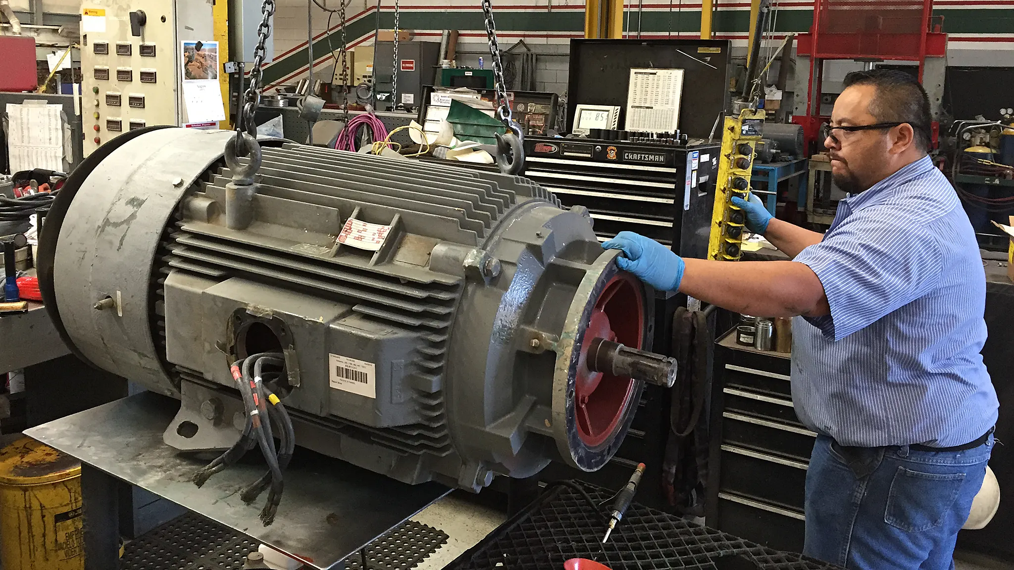 Technician working on electric motor.