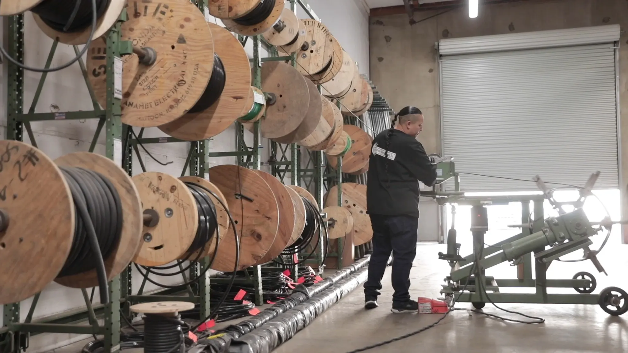 Employee measuring electrical wire