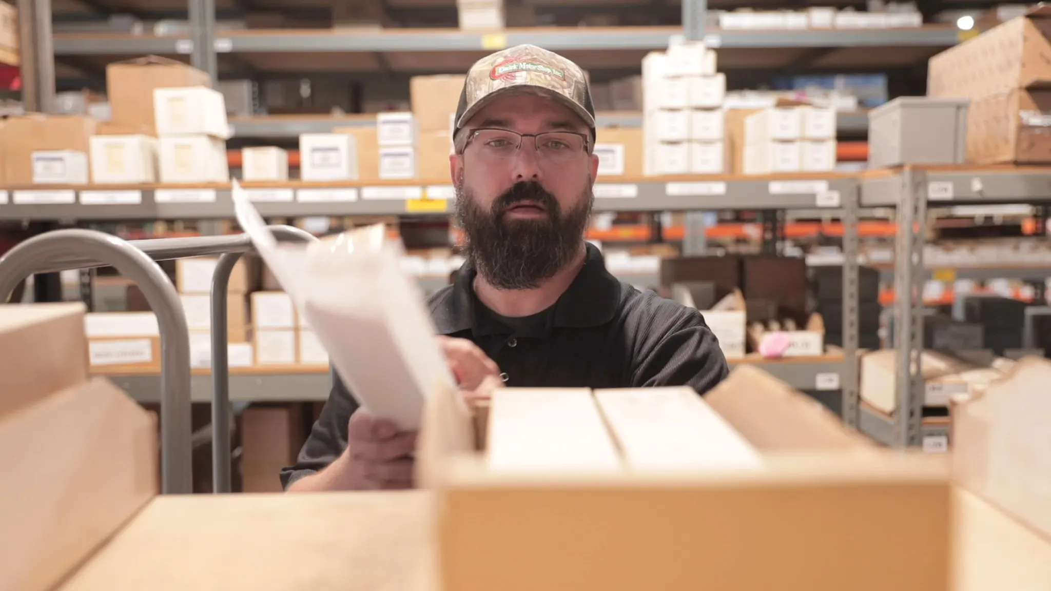 Employee pulling inventory from shelving.