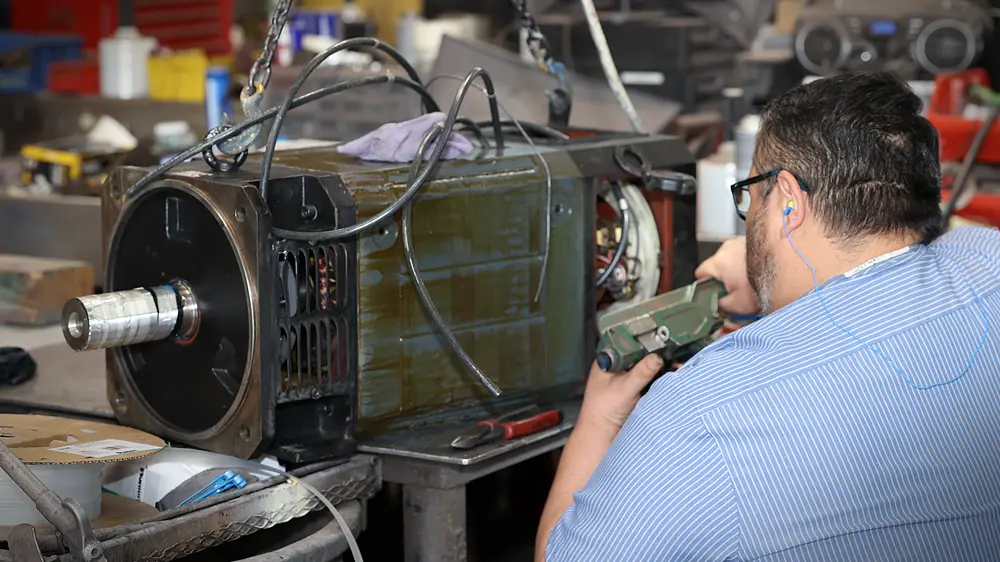Technician working on electric motor.