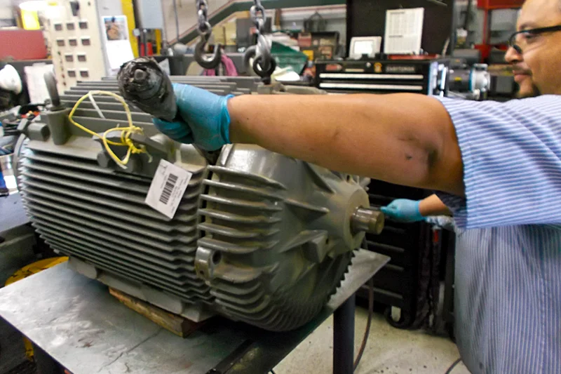 Electric Motor Shop technician preparing to disassemble electric motor and inspect internal components.