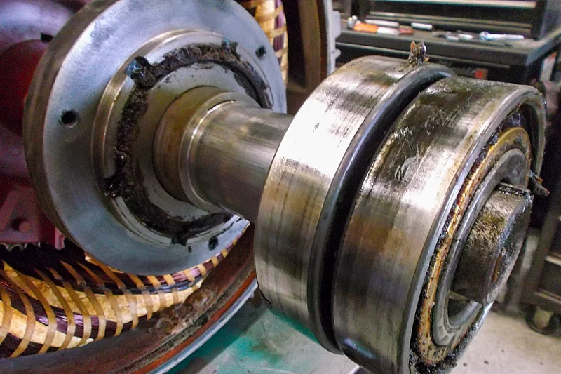 Close-up of worn motor bearing and shaft damage discovered during visual inspection.