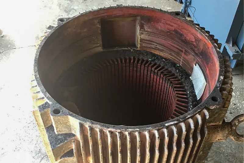 Stator core with all coils removed, ready for cleaning and rewinding after winding specs are documented.