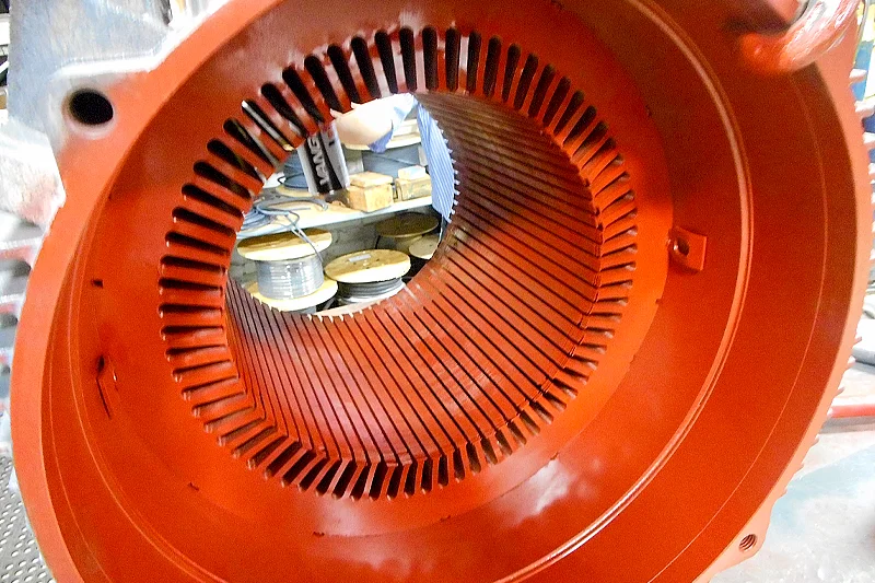 Fully enamel-coated stator core with prepared slots, ready for coil insertion during motor rewind process.