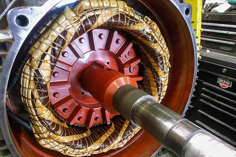 Rotor fully inserted into the stator with neatly wound and cured coils visible around it, showing precise installation and assembly.