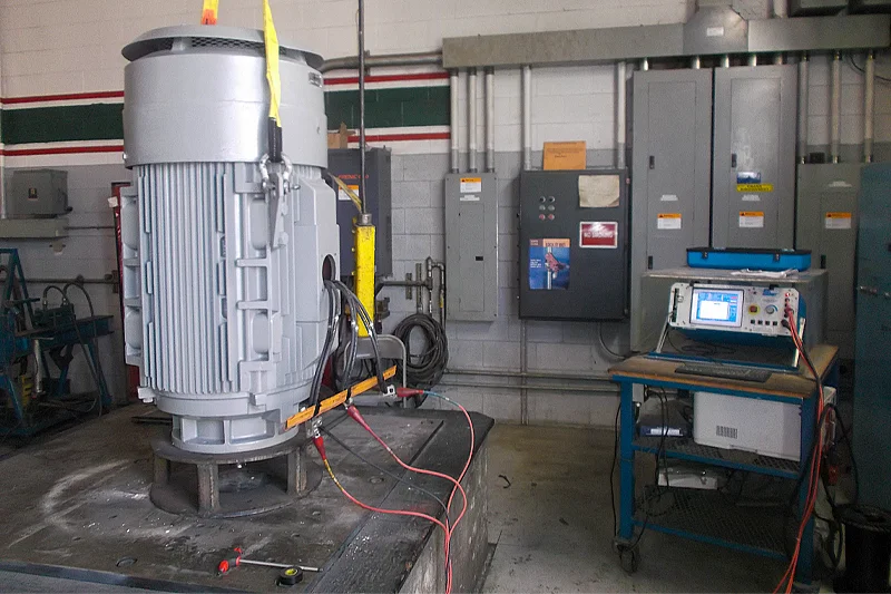Final electrical testing of industrial electric motor using surge tester and hi-pot equipment in a motor repair facility.