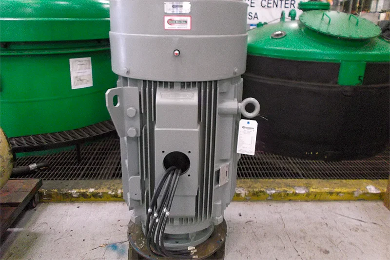 Fully repaired industrial electric motor cleaned, labeled, and prepared for customer pickup with final inspection tag attached.