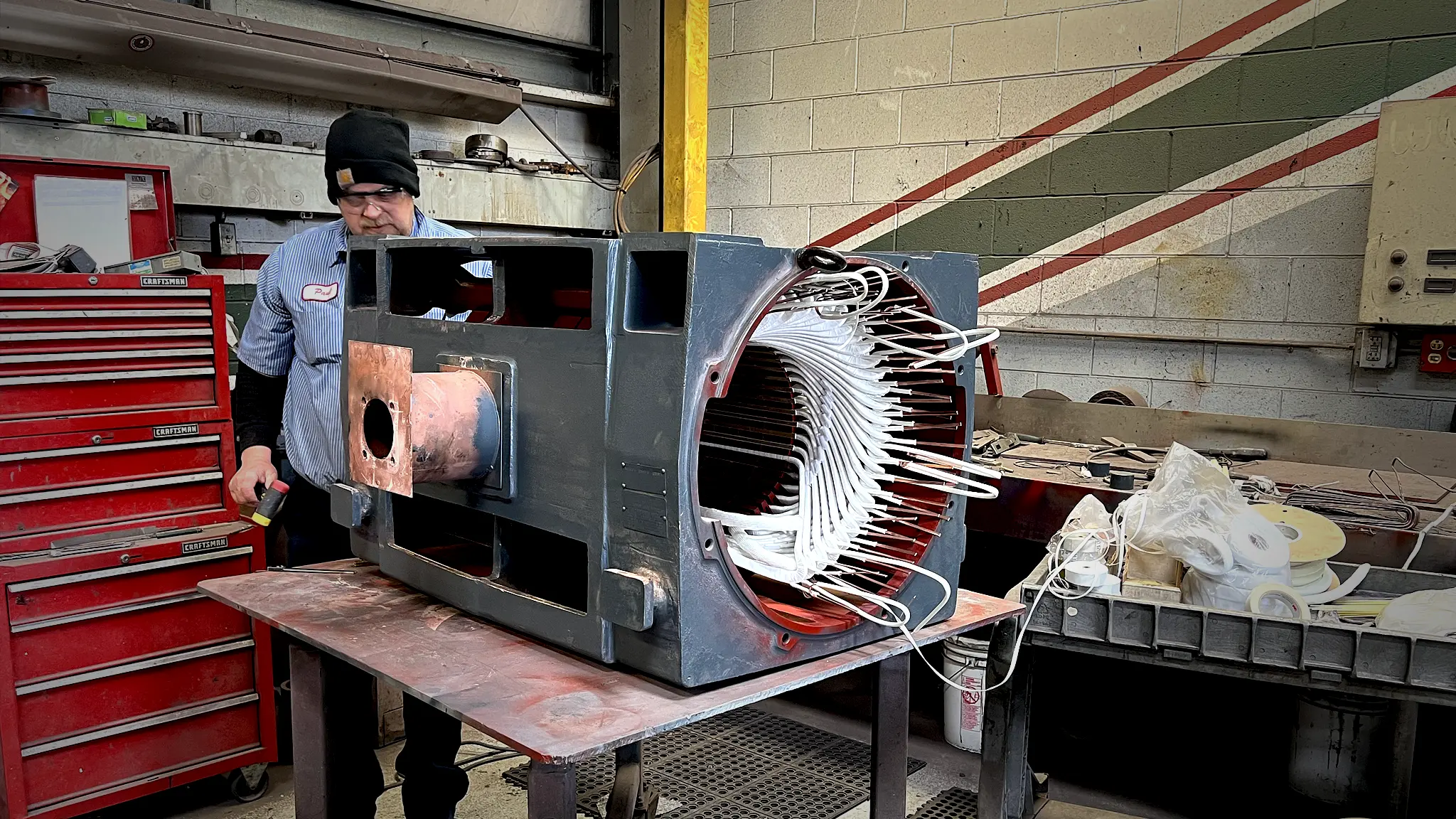 Technician working on electric motor.